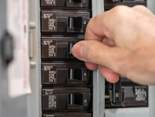 someone flips a switch on an electrical panel